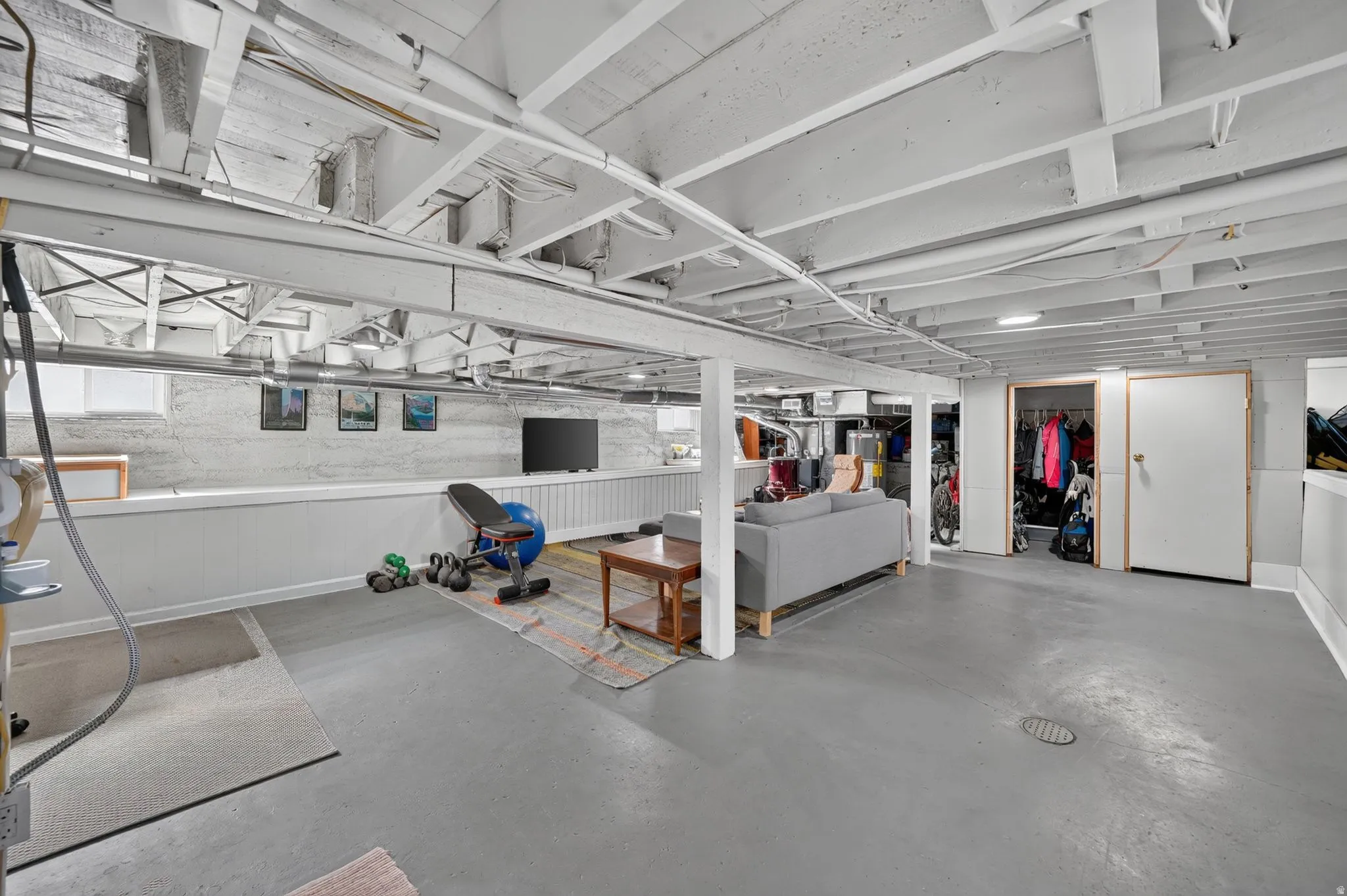 Painted concrete flooring and exposed ceiling joists