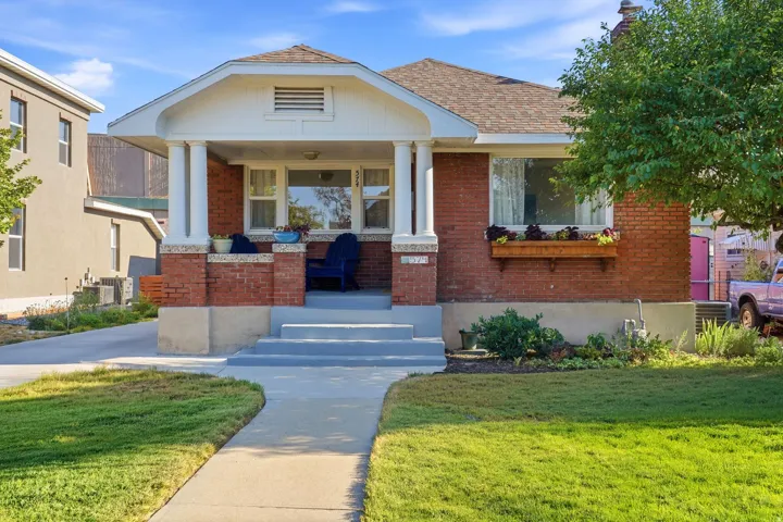 Brick facade with a covered front porch, columns, and a window box