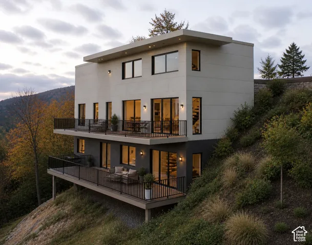 Modern multi-level exterior with an expansive deck, black metal railings, and a flat roof design