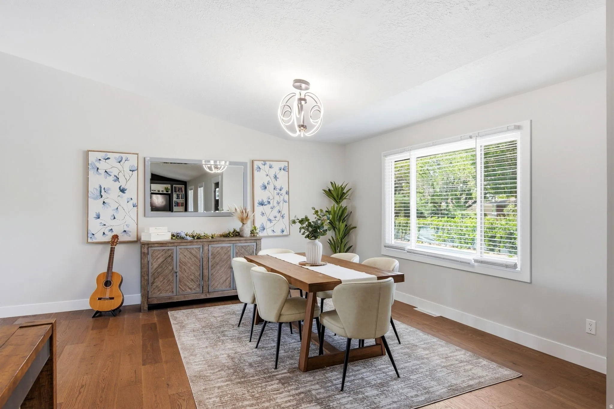Wood-finish flooring, recessed lighting, and a contemporary chandelier