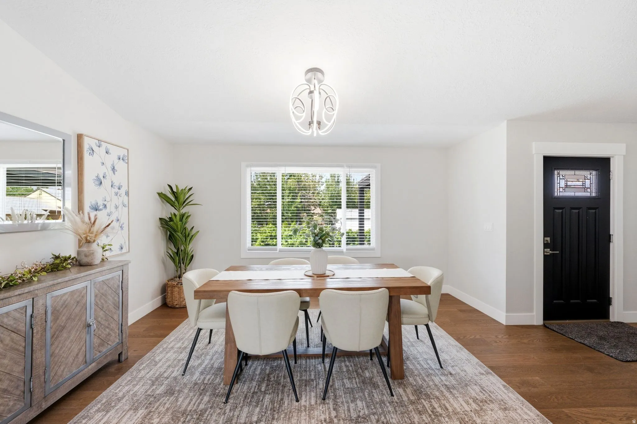 Wood-finish flooring throughout, complemented by a decorative overhead light fixture