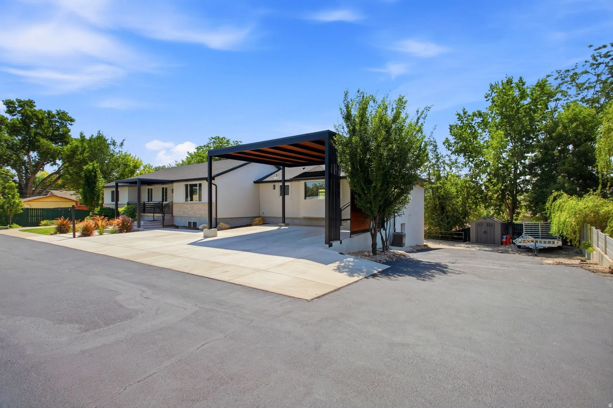 Stucco exterior with stone accent, covered entry, and attached carport