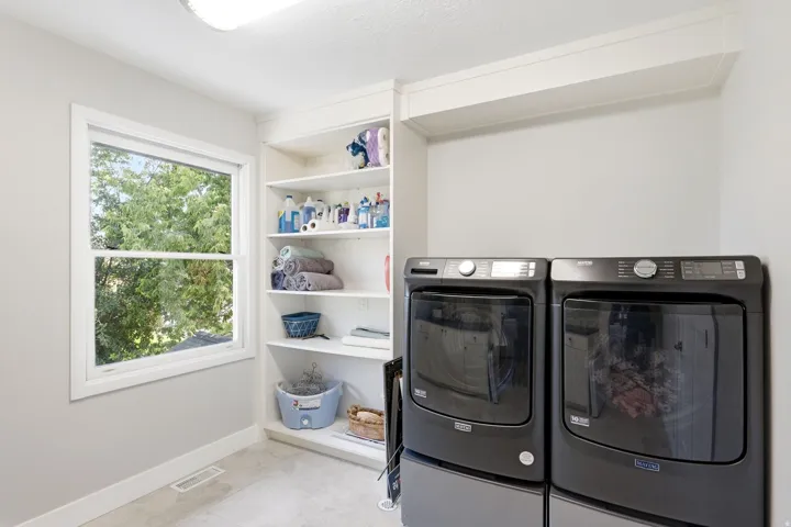 Built-in shelving, white trim window, light gray wall color, flush mount ceiling light