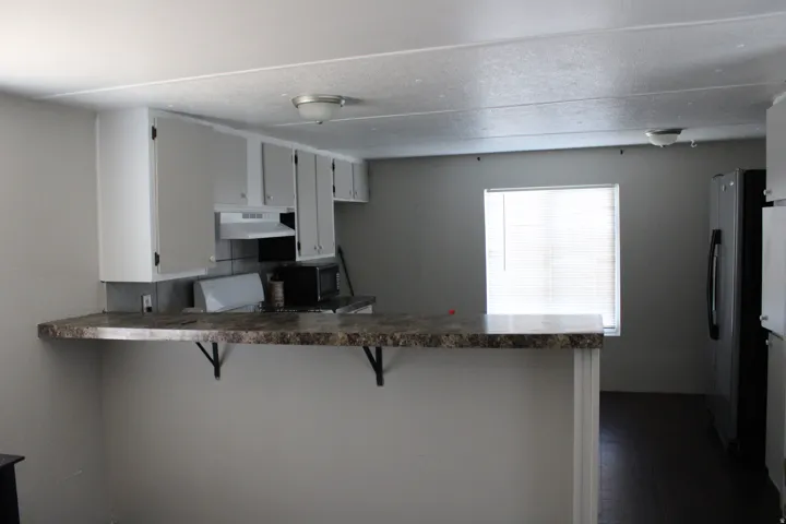 Kitchen featuring light-toned cabinetry, a built-in oven, and a refrigerator