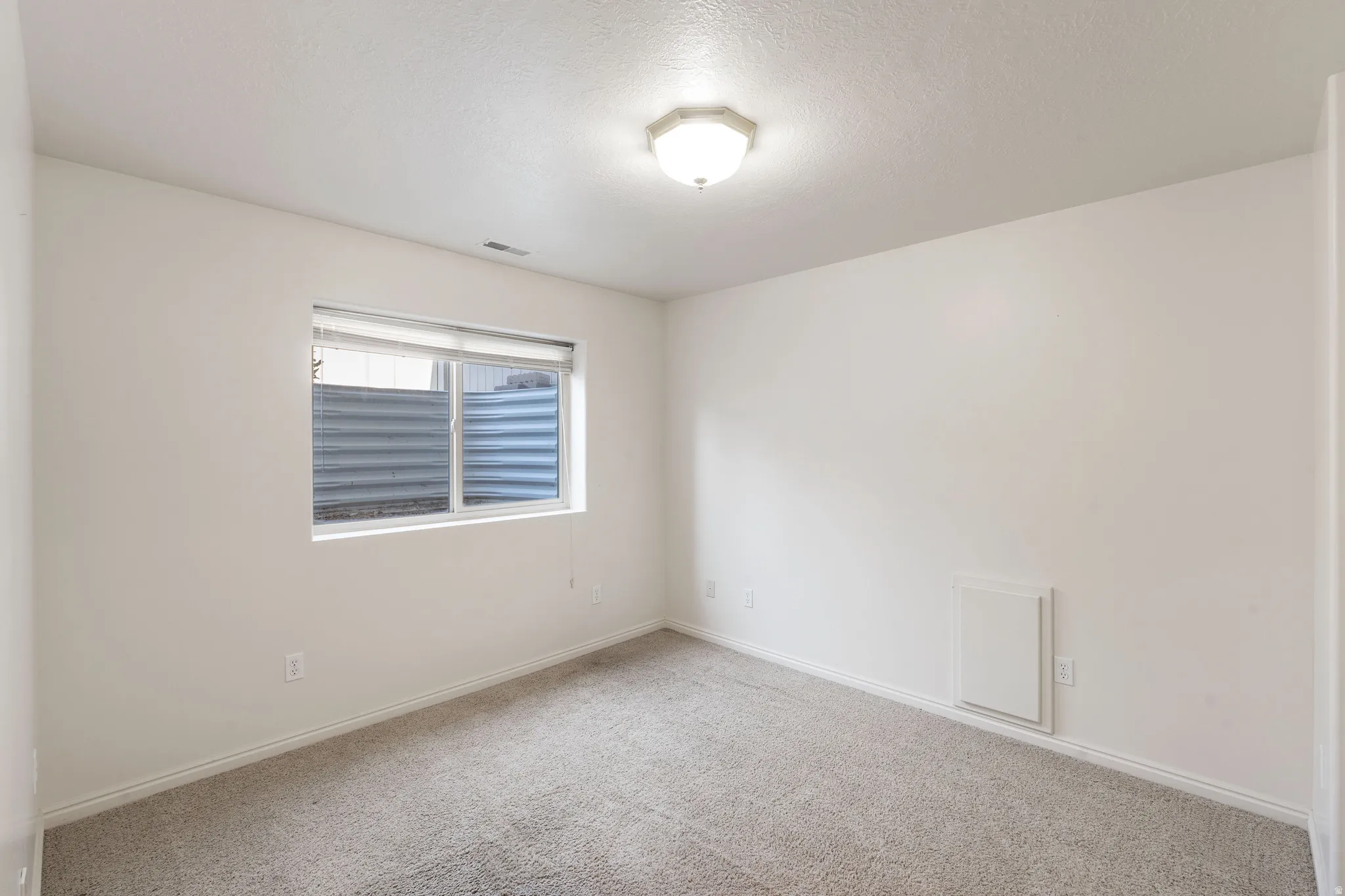 Wall-to-wall carpeting with light-toned walls and trim