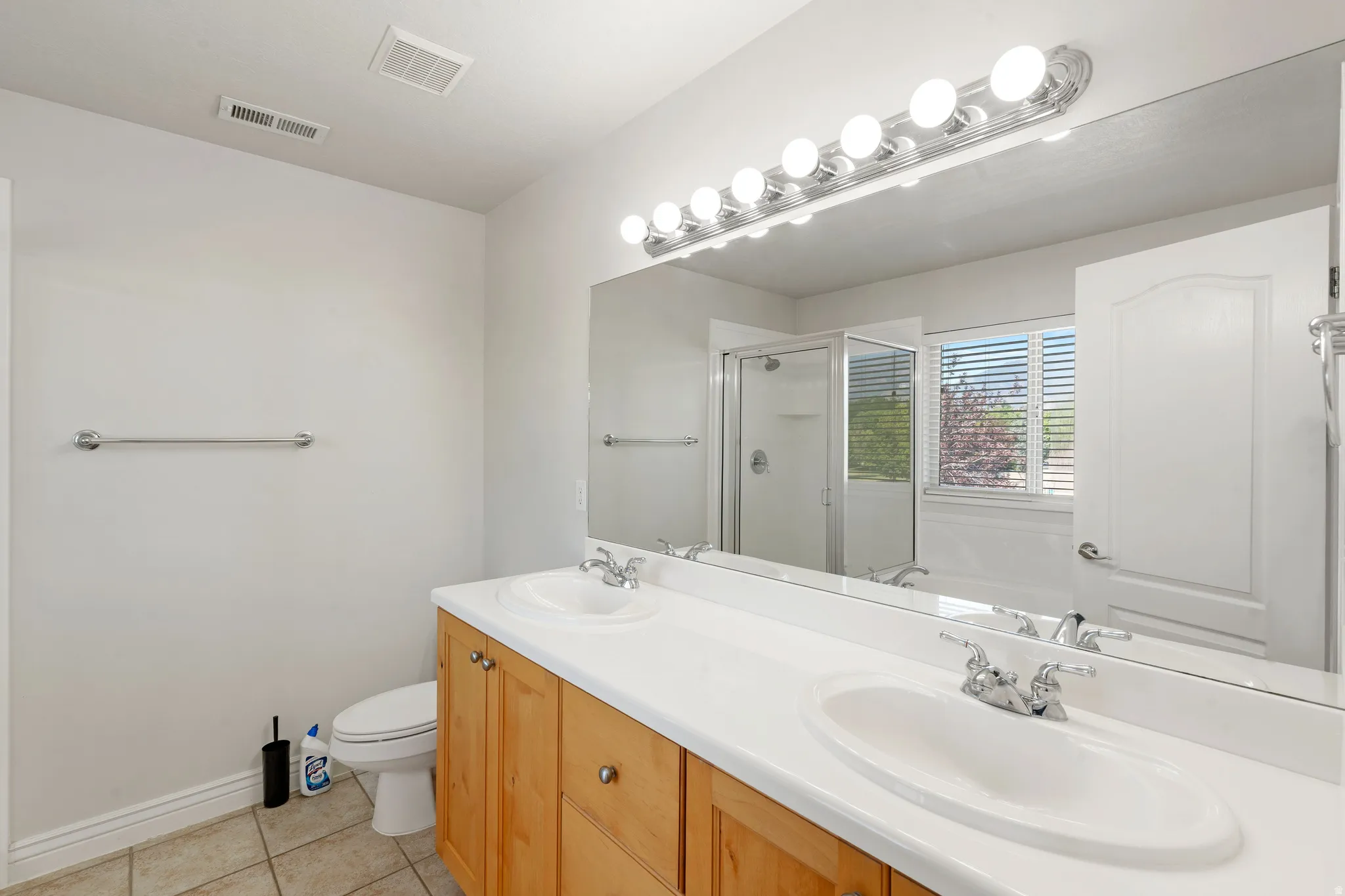 Dual vanity with integrated sinks and wood-finish cabinetry