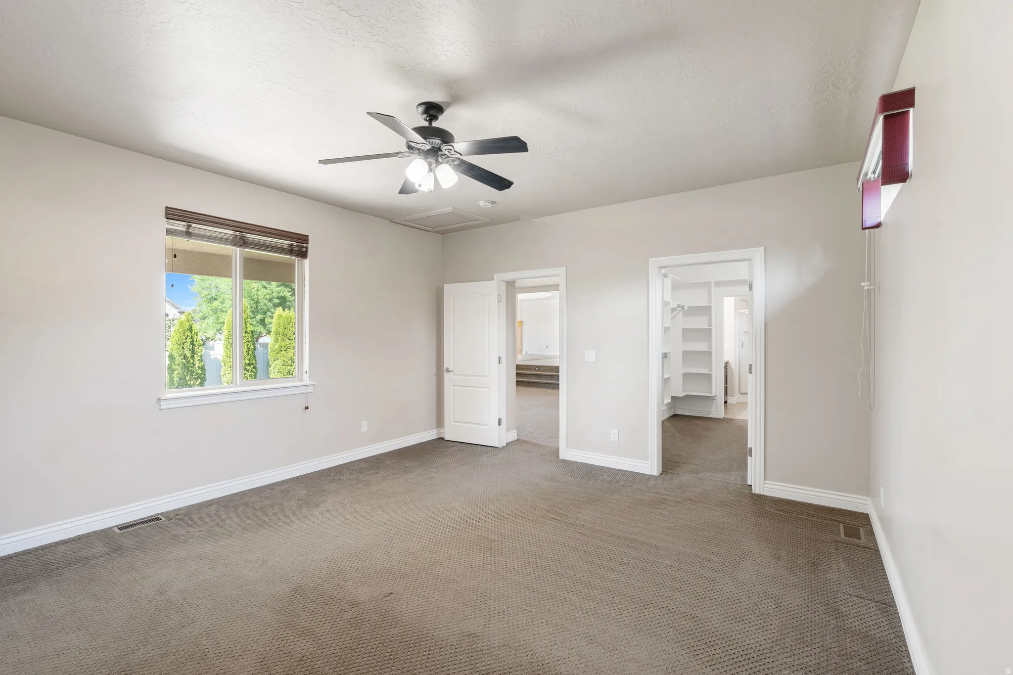 Window with wood-finish blinds, ceiling fan, and carpeted flooring