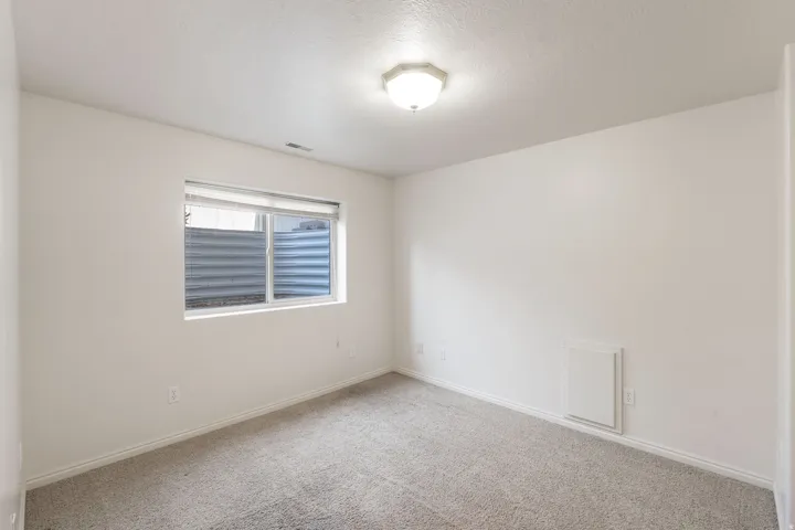Wall-to-wall carpeting with light-toned walls and trim