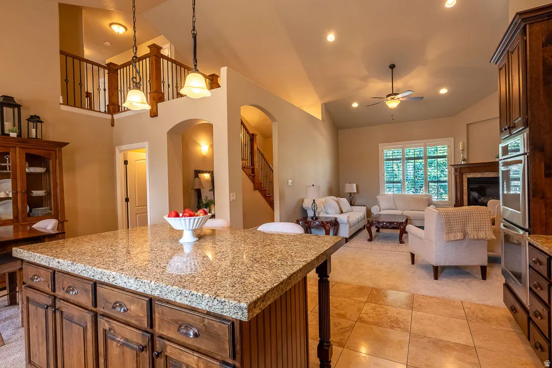 Kitchen island with granite countertop and wood cabinetry