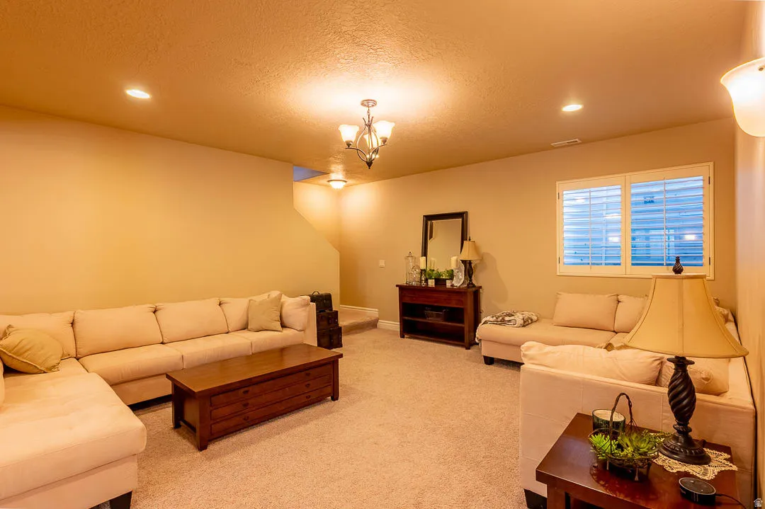 Recessed lighting, chandelier, and wall sconce fixtures provide ample illumination