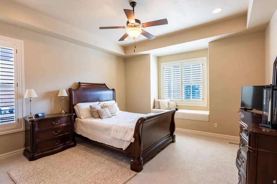 Recessed lighting, ceiling fan, carpeted flooring, window with plantation shutters, and a built-in window bench