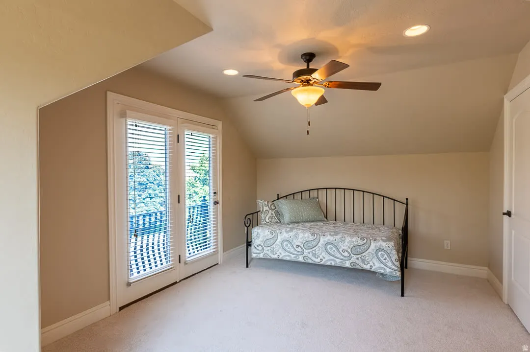 Recessed lighting, ceiling fan with light fixture, white paneled door, and glass French doors with internal blinds