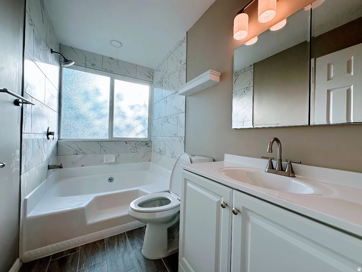 White vanity with dual-door cabinetry, single basin sink, and chrome faucet