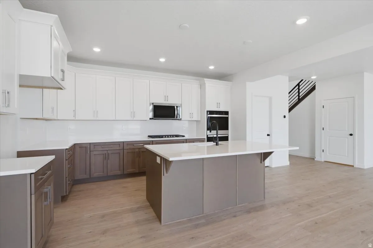 Spacious Cabinets with Easy to Clean Full Quartz Backsplash