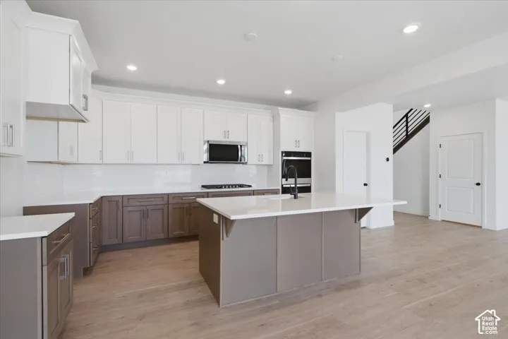 Spacious Cabinets with Easy to Clean Full Quartz Backsplash