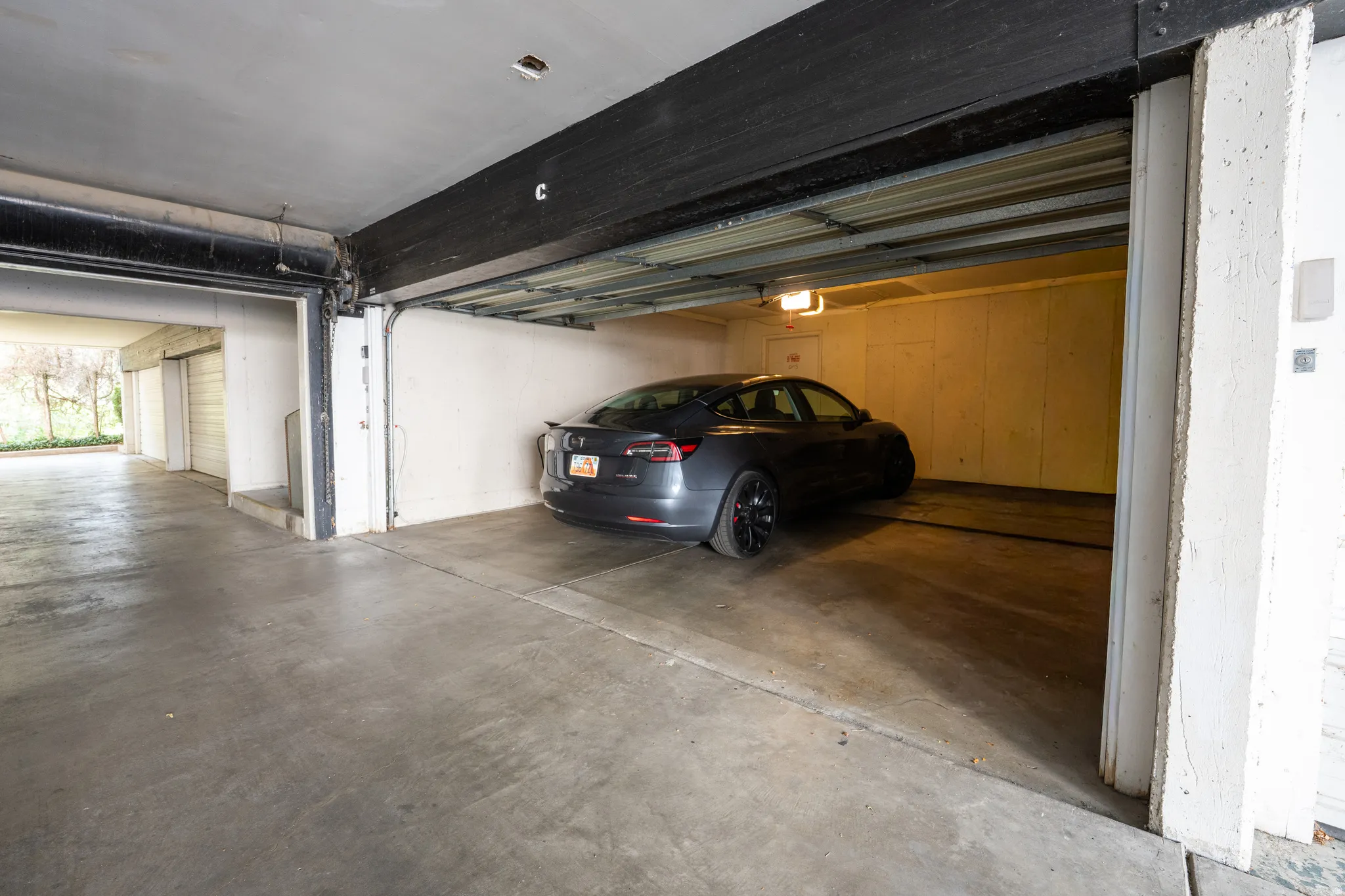 Concrete flooring in a single-car garage with an automatic door
