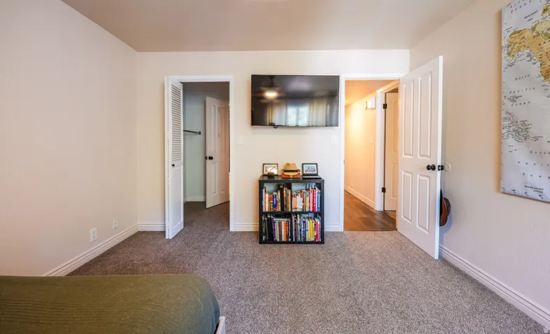 Neutral-toned carpeting, white trim, and white walls