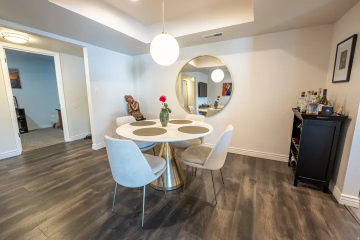 Wood-finish flooring throughout, complemented by white baseboards and neutral wall tones