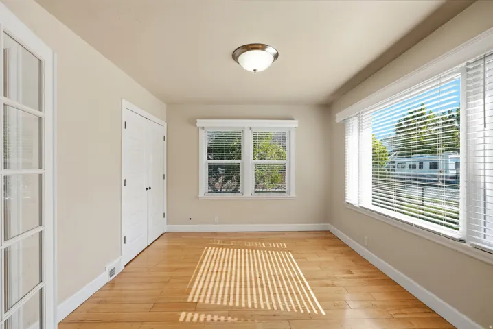 Wood-finish flooring, white trim, recessed lighting, and ample natural light from multiple windows