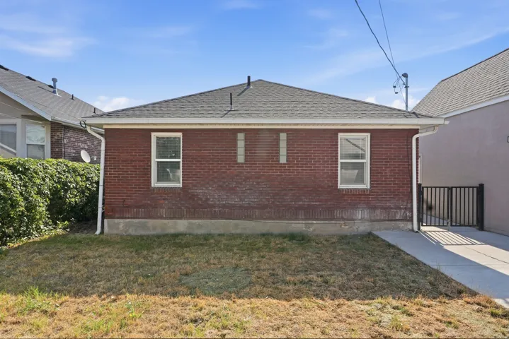Brick exterior with a gray shingled roof