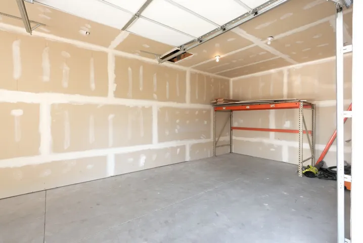 Unfinished interior walls, exposed ceiling joists, and a concrete floor