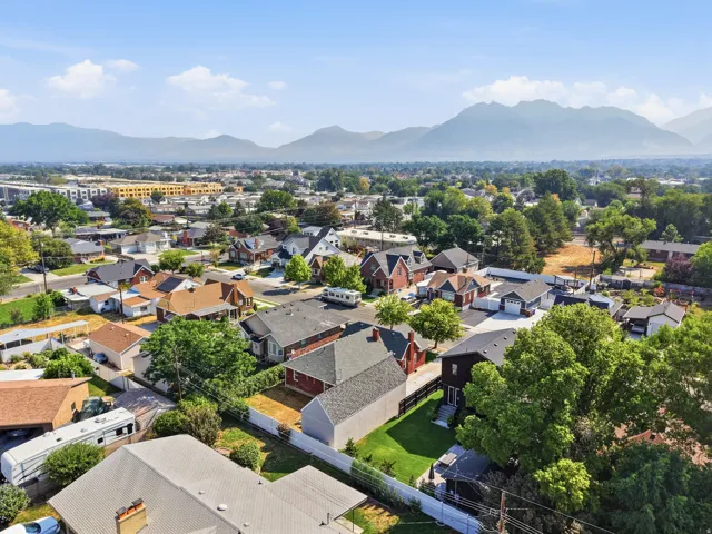Expansive mountain backdrop with a dense residential area featuring a variety of rooflines and mature trees