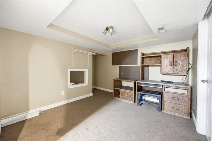 Recessed ceiling details, built-in shelving, and a built-in desk unit