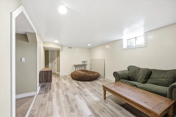 Recessed lighting illuminates wood-finish flooring