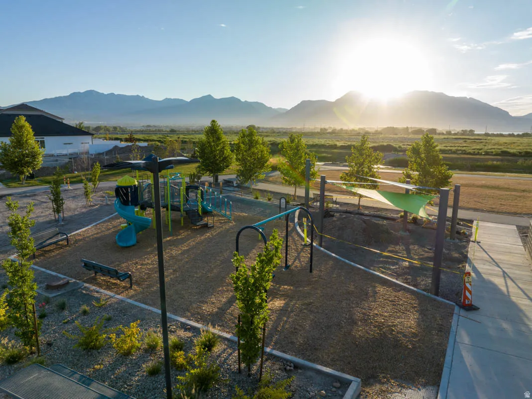 Community playground featuring a spiral slide, climbing structure, and ground-level benches