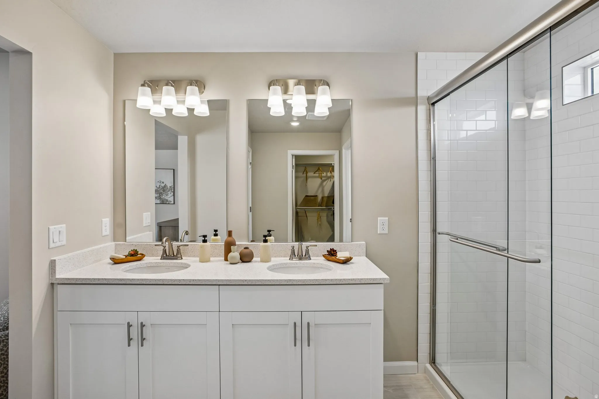 Dual vanity with white cabinetry, light-toned countertop, and undermount sinks