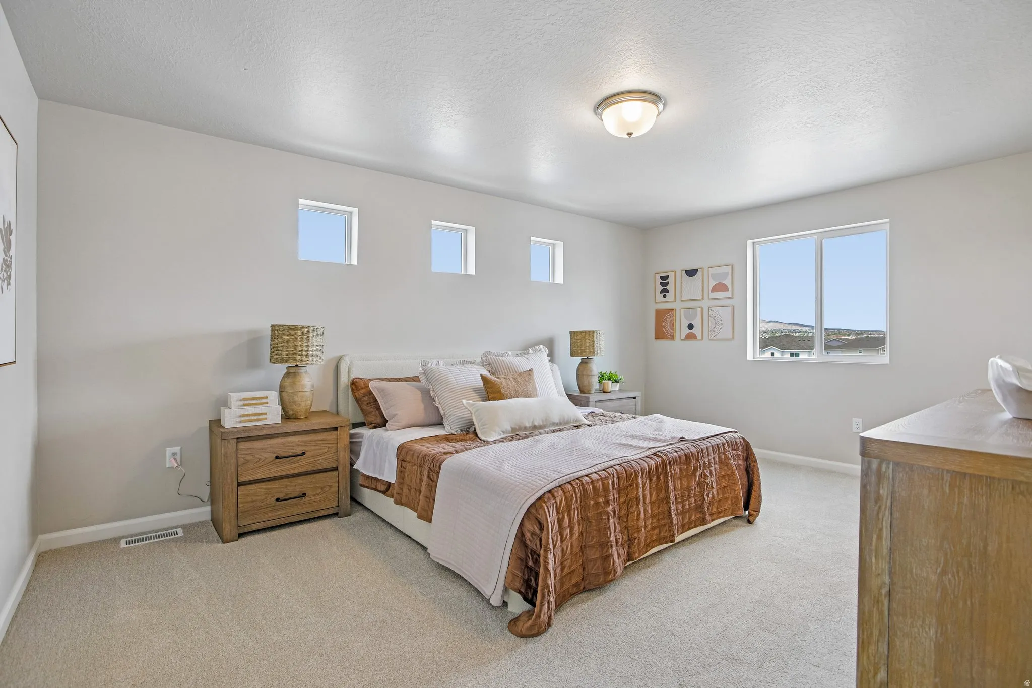 Bright room with light-toned wall finishes, carpeted flooring, and a flush mount ceiling light fixture