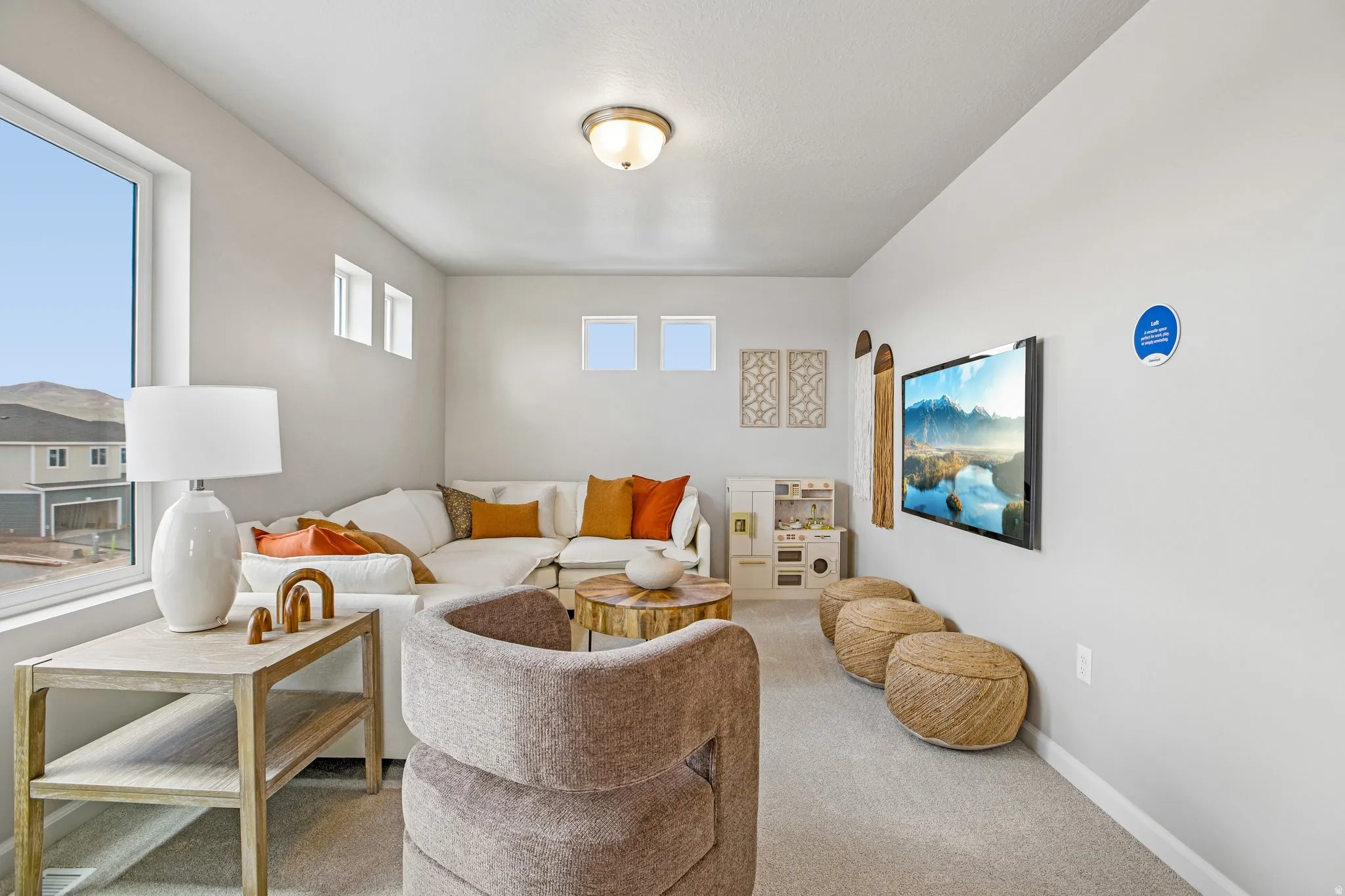 Carpeted room with a large window and multiple transom windows