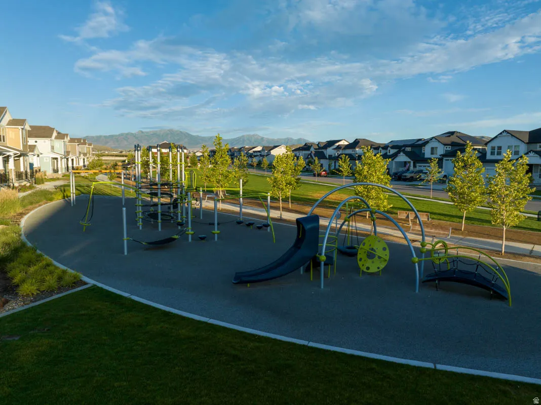 Community playground featuring multiple play structures, swings, and a slide