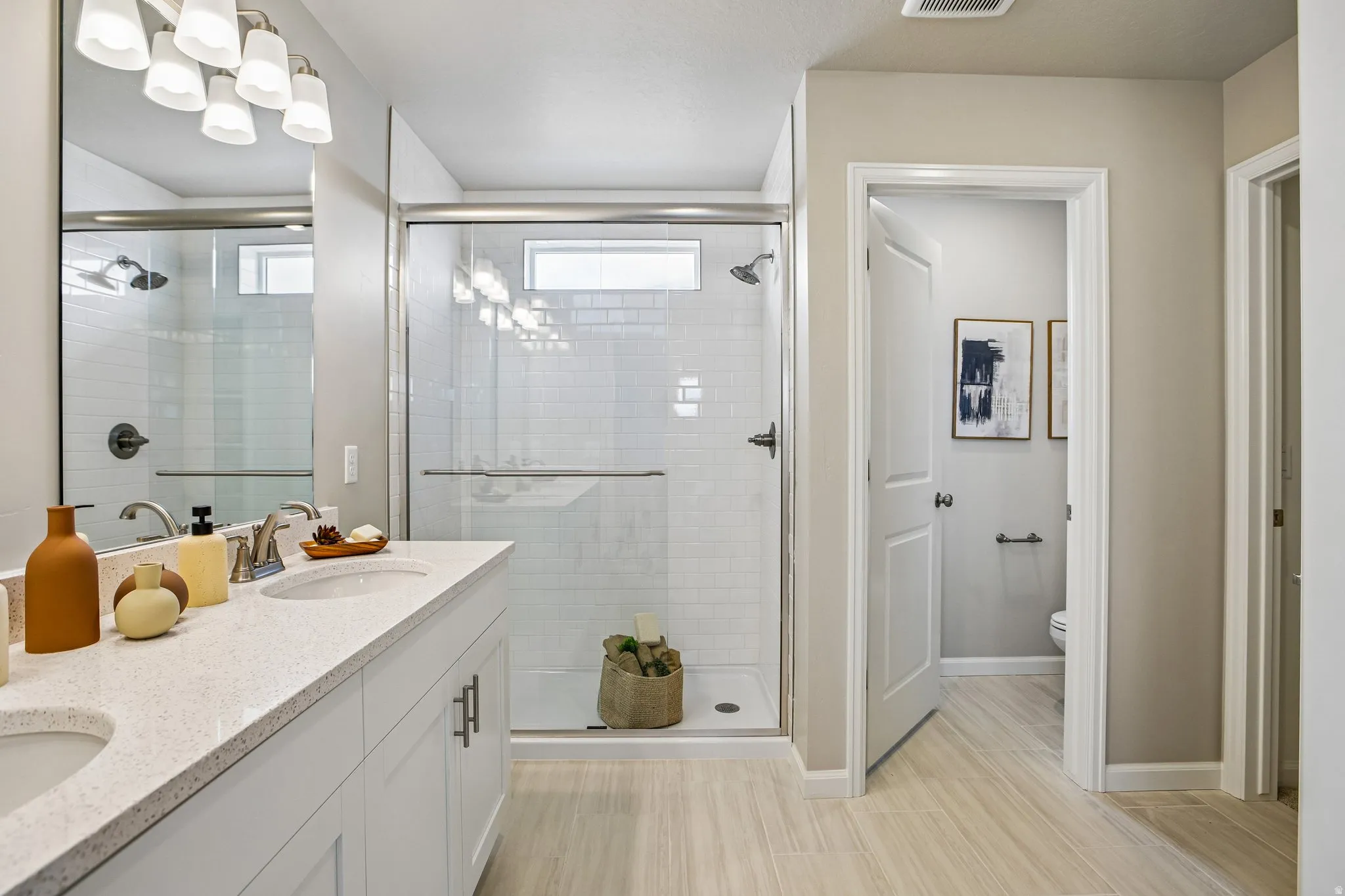 Dual vanity with white cabinetry and light-colored countertops