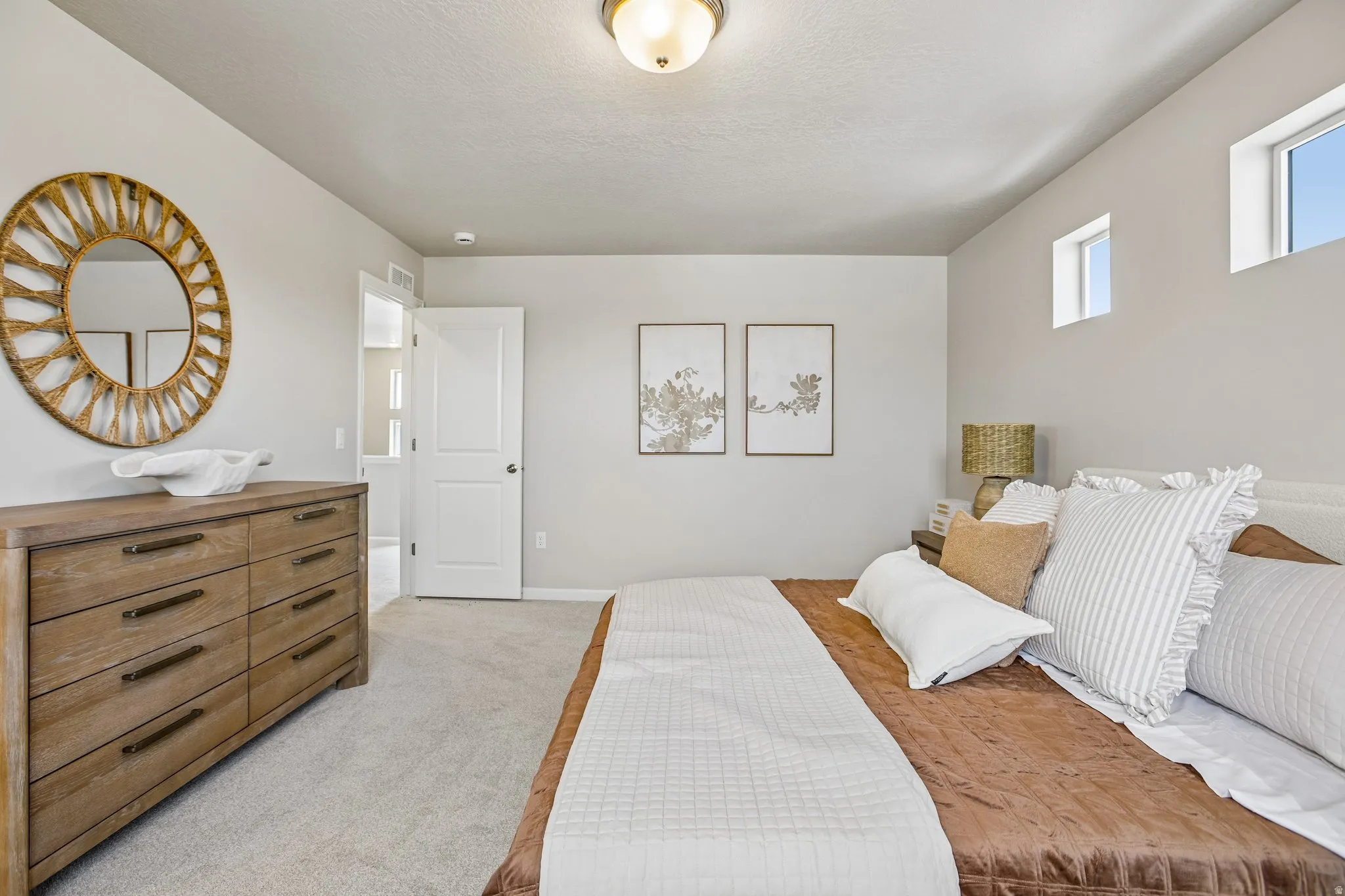 Recessed lighting, light-colored walls, carpeted flooring, and white trim