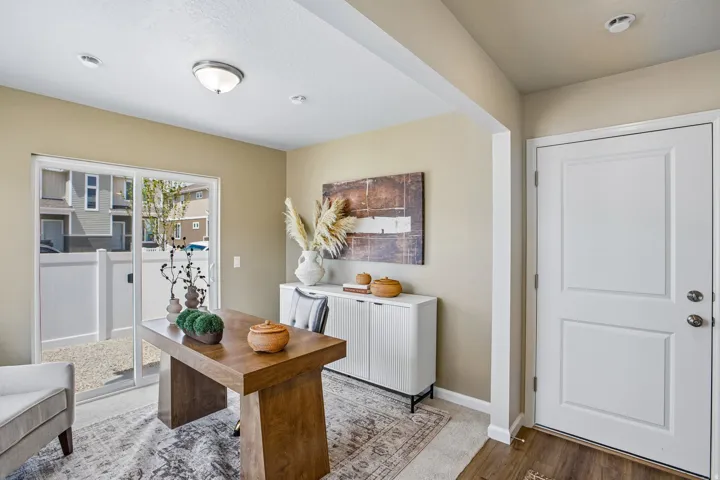 Sliding glass door leading to an outdoor area, recessed lighting, ceiling-mounted light fixture, and paneled entry door