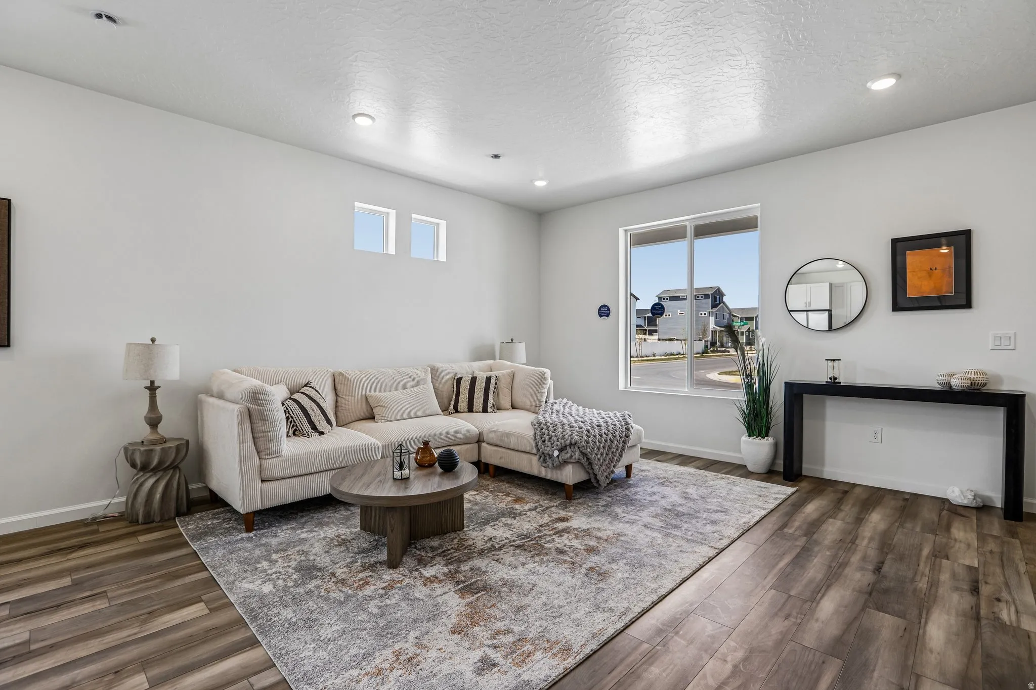 Recessed ceiling lighting, wood-finish flooring, and a large sliding window