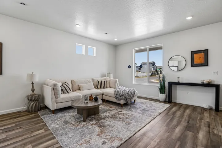 Recessed ceiling lighting, wood-finish flooring, and a large sliding window
