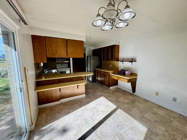 Kitchen area featuring wood cabinetry, laminate countertops, and stainless steel appliances