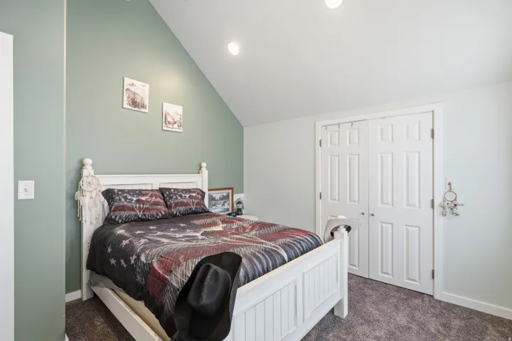 Vaulted ceiling, recessed lighting, neutral wall paint, paneled bifold closet doors, and gray carpet flooring