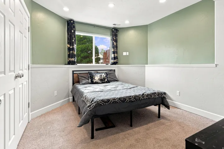 Recessed lighting illuminates the space, featuring a window and textured walls