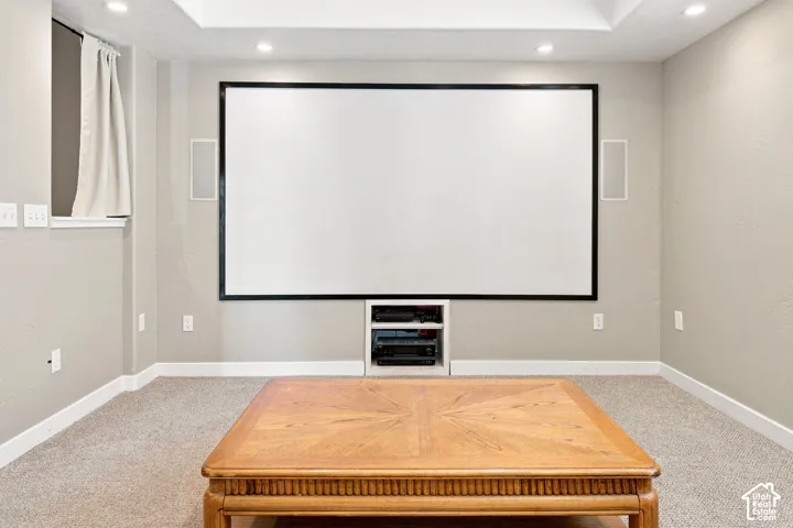 Integrated projection screen with built-in media shelving, recessed lighting, and tray ceiling detail