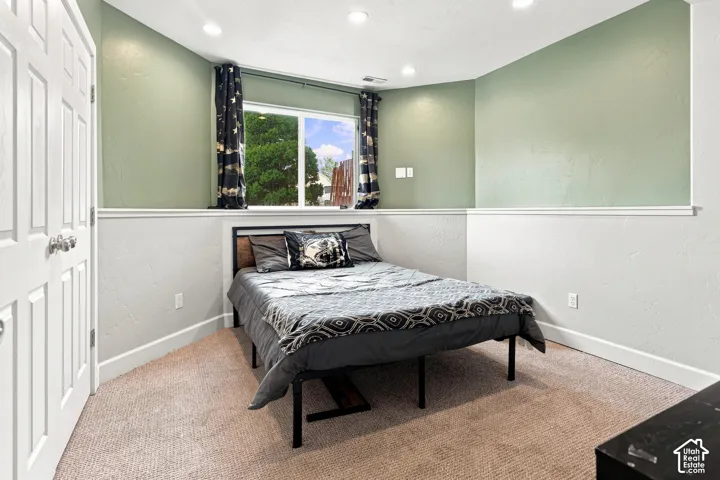 Recessed lighting illuminates the space, featuring a window and textured walls