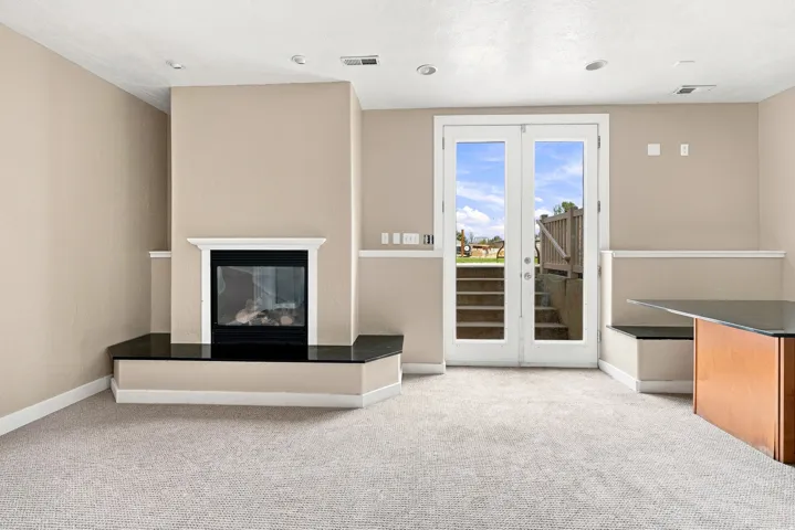 Built-in fireplace with a black surround and dark stone hearth