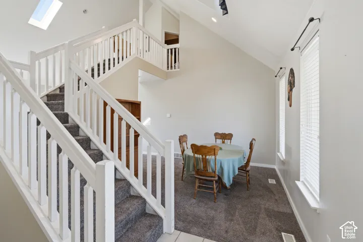 White-painted staircase with gray carpeted treads