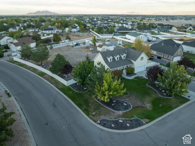 Single-story residence with dormer windows, attached garage, and landscaped front yard
