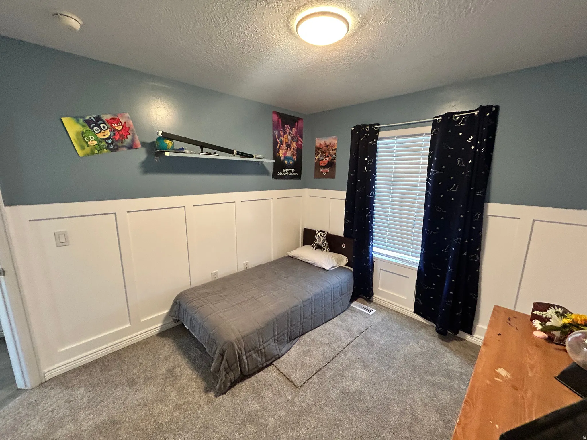 Wall paneling with a painted finish, a mounted wall shelf, and a window with blinds