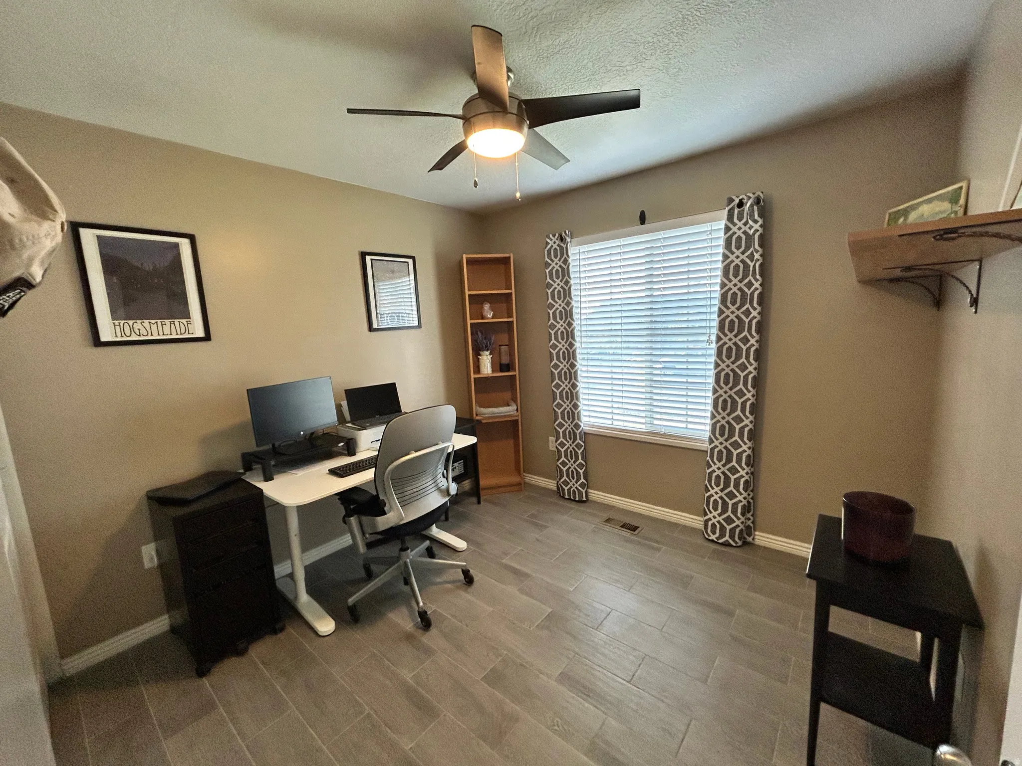 Recessed lighting, wood-finish tile flooring, ceiling fan with integrated lighting, built-in wooden shelving, and a wall-mounted wooden shelf
