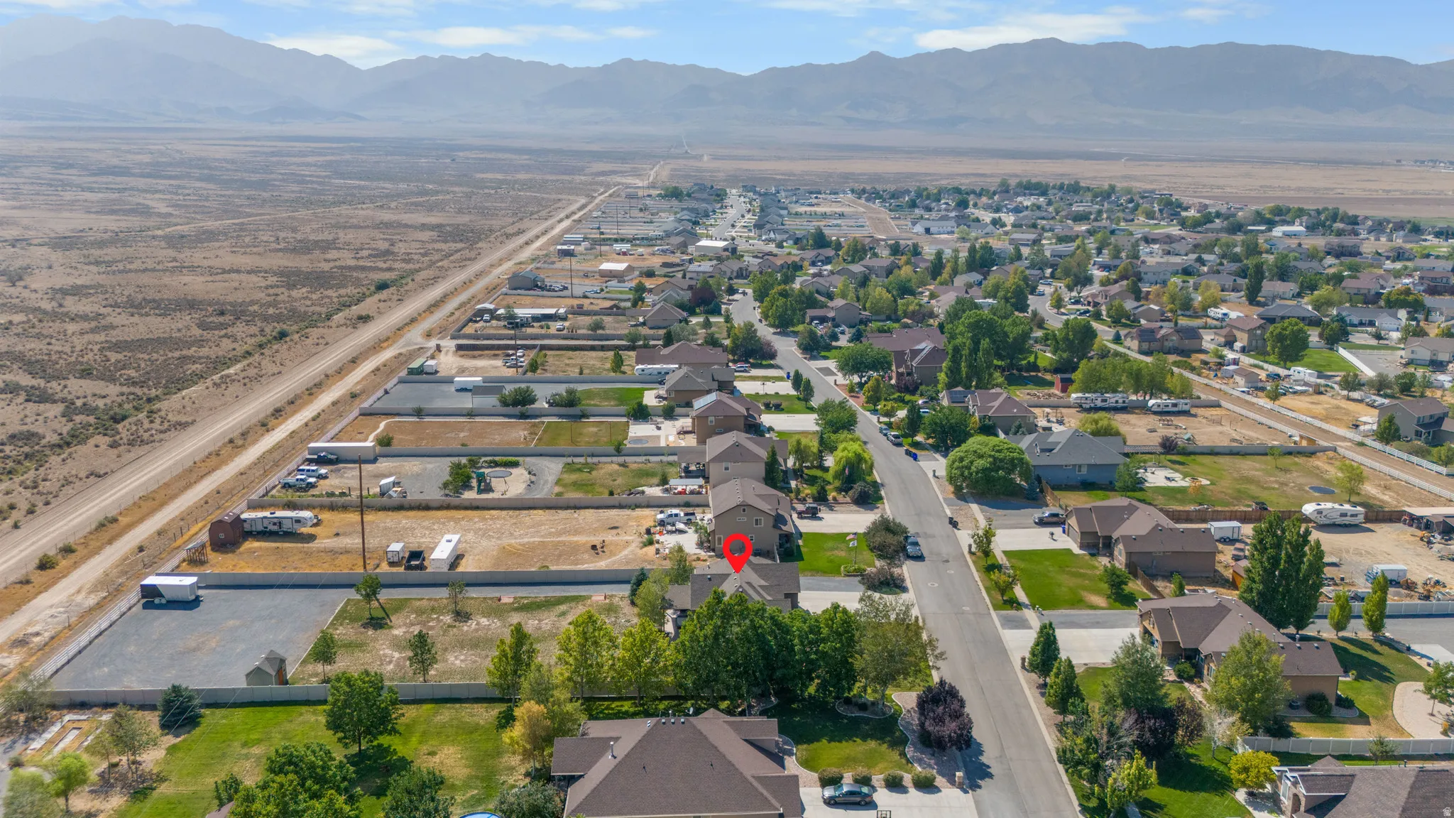 Residential development with established homes, paved streets, and mature trees