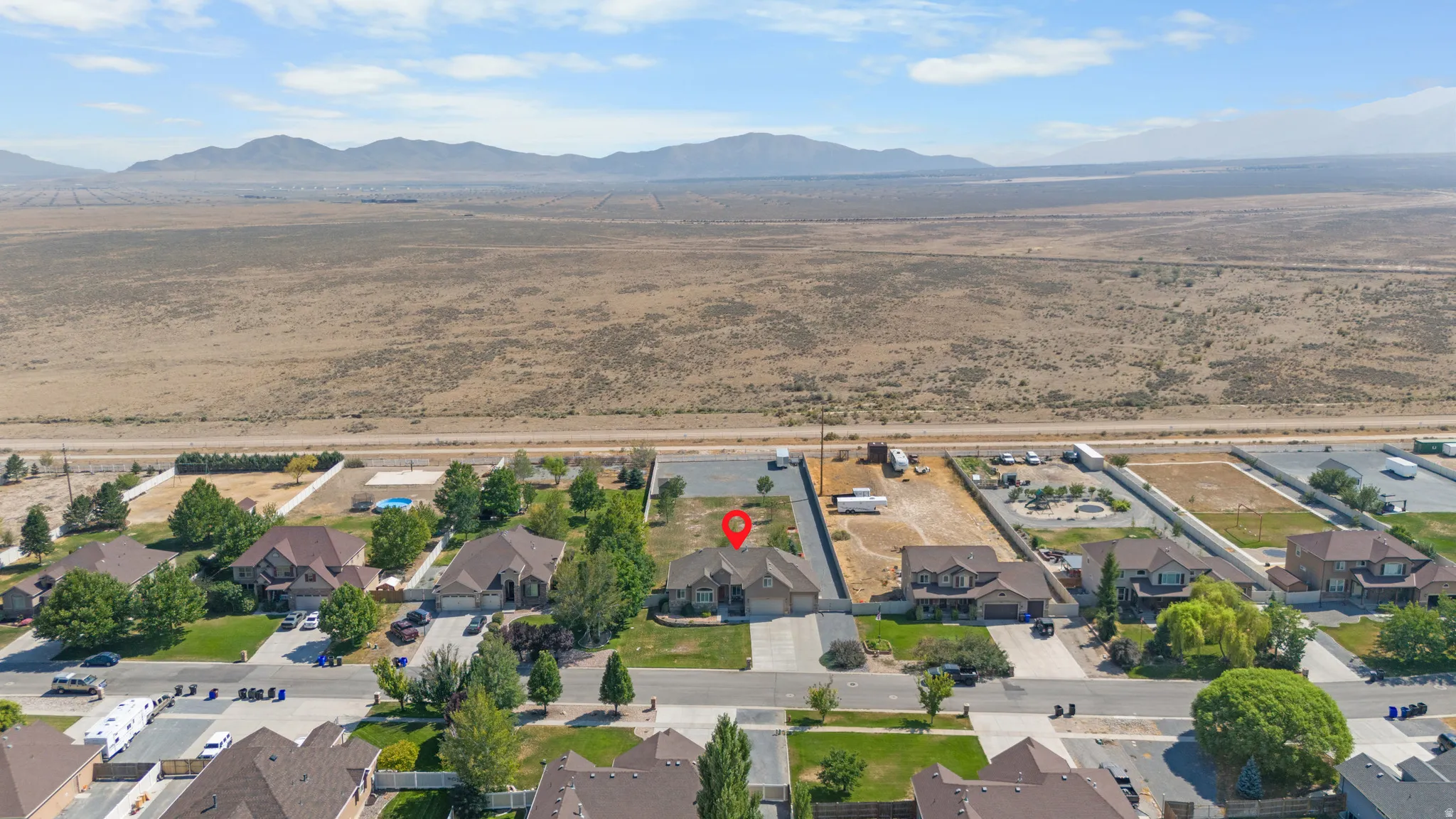 Residential property with a landscaped front yard, concrete driveway, and attached garage